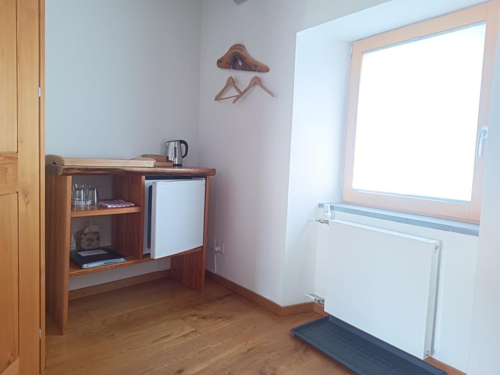view living room area with mini fridge, kettle and tea selection